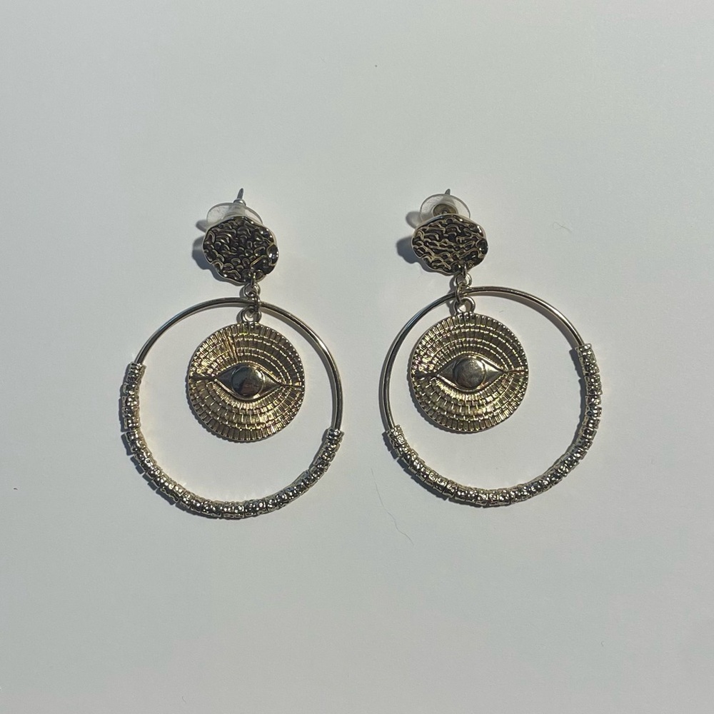 Gold toned circle hoop earrings with Eye Design.
